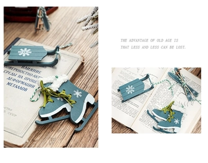 Detail of vintage wooden ice skate and sled ornaments with plush trim for Christmas tree