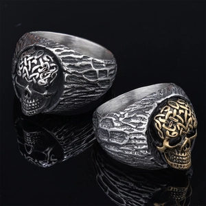 Gothic punk skull ring in silver and gold tone with Celtic knot and stone texture