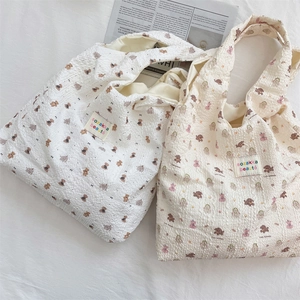 Detailed close-up of textured bubble fabric tote bag with cute bear pattern embossed