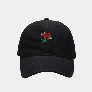 Classic black baseball cap with vibrant red rose embroidery on a minimalist gray background