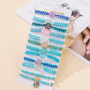 Detailed set of 12 braided beaded bracelets with mixed metal charms on display card