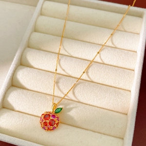 Close-up of 14k gold plated apple pendant with vibrant colorful zircon crystals