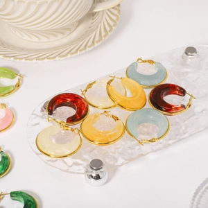 Elegant U-shaped resin hoop earrings with gold trim and colorful marble textures