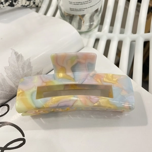 Acetate hair claw clip with colorful square mosaic patterns and hollow rectangle design