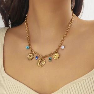 Gold plated stainless steel necklace with sun moon and turquoise charms on a model