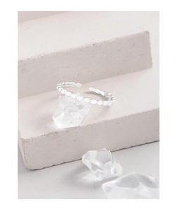 Detail of S925 sterling silver adjustable ring with beaded texture on stone steps