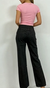 Vue arrière du jean noir taille haute avec imprimé et t-shirt rose ajusté