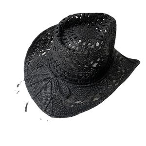 Handmade black woven straw cowboy hat with cutout patterns and natural fiber texture
