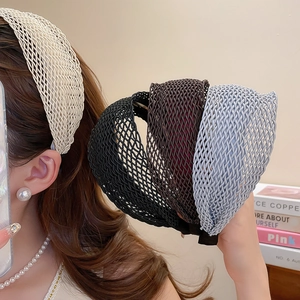 Detail of Korean woven wide headband showing textured mesh fabric and layered design in four colors