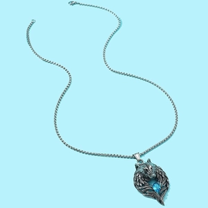 Vintage silver wolf head necklace featuring a centerpiece oval blue gemstone pendant