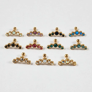 Matrix of curved stainless steel ear studs with white opal and colored gemstones