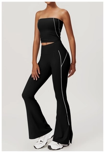 Detail of black yoga set with white contrast stitching on tube top and flared pants