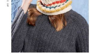 Detail of winter knitted snood with colorful stripes and soft faux fur trim for warmth