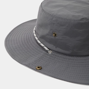 Macro detail of waterproof hiking hat with braided chin strap and metal snap buttons