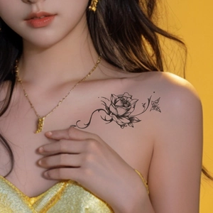 Elegant floral temporary tattoo with black rose and butterfly design on woman's shoulder