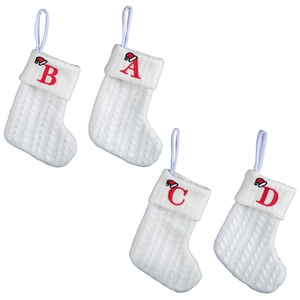 Set of four white knitted Christmas stockings with red embroidered letters A, B, C, D and caps