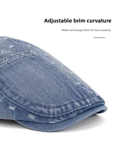 Macro detail of washed denim newsboy cap with adjustable wide brim and white stitching