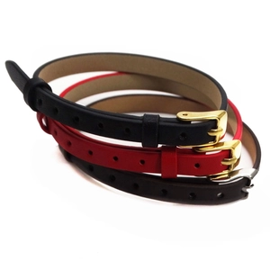 Detail view of 10mm leather wristbands in black, red, and brown with metal buckles
