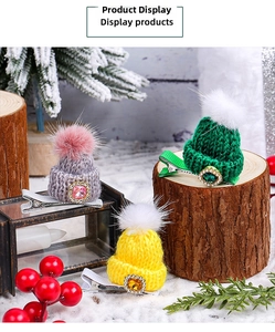 Detailed view of colorful knitted mini hat hair clips with gems in a festive winter setting