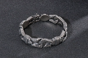 Close-up of retro geometric men's titanium steel bracelet with gothic carving details