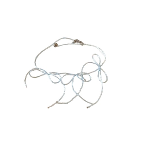 Elegant light blue and white beaded bow necklace for women on a clean white background