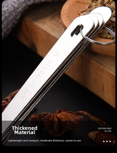 Detailed close-up of heart-shaped stainless steel measuring spoon with engraved text