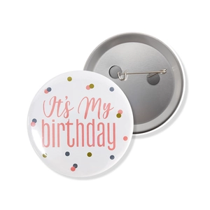 Detail view of pink Happy Birthday tinplate badge with secure safety pin on white background