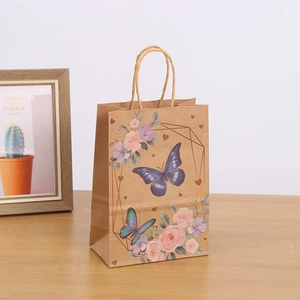 Brown kraft paper gift bag with floral butterfly print and twisted paper handles