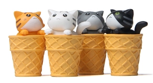 Detailed view of four miniature cats sitting in waffle cones for garden landscaping