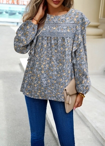 Detailed view of floral long sleeve blouse with lace hollow and ruffled shoulders