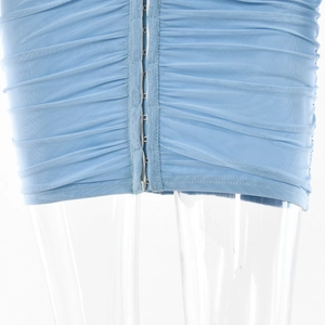 Detail of light blue mesh mini dress featuring horizontal ruching and front hook-and-eye closure