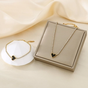 Elegant gold-plated stainless steel jewelry set with black heart charms and white zircons