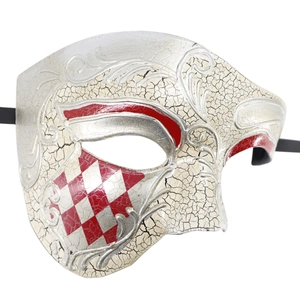 Detail of vintage Phantom mask with silver cracks and red checkered patterns on white