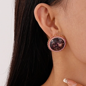 Boucles d'oreilles vintage rondes avec cristaux roses et feuille d'or sur modèle