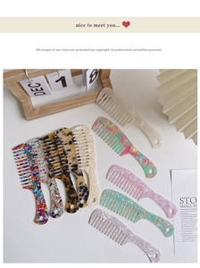 Macro view of wide-tooth acetate hair combs with colorful marble and floral patterns