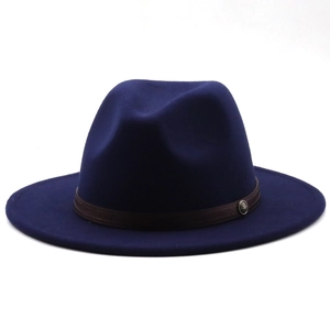 Detail of the navy wool fedora showing the brown woven leather band and metal emblem