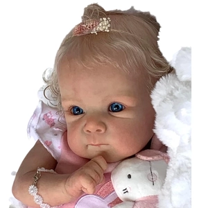 Lifelike 18-inch Bettie reborn baby doll with blonde curls and pink patterned outfit