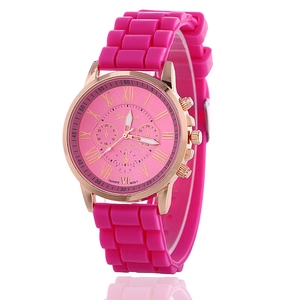 Detail of pink silicone strap and rose gold Geneva quartz watch with roman numerals