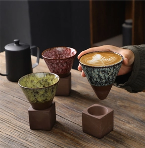 Detailed close-up of handmade rustic ceramic coffee mugs with unique cracked glaze texture