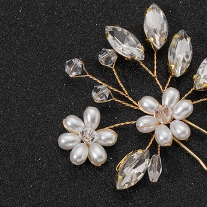 Detailed macro view of handmade bridal hair pins with white pearls and crystals