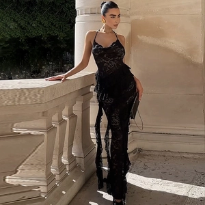 Detail of elegant black lace ruffles and intricate floral textures on a slim maxi dress
