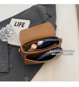 Detail view of the spacious interior compartment with leather texture and zip pocket