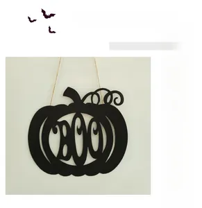 Detail of black metal Halloween pumpkin sign featuring BOO lettering for wall decoration