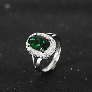 Macro detail of silver ring featuring green opal stone and sparkling diamond halo