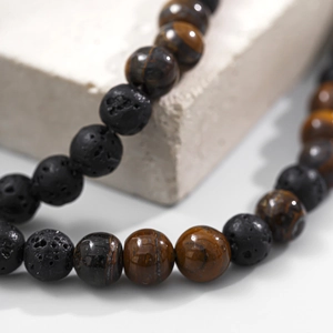 Macro shot of tiger eye and lava stone beads on a men's hip hop style necklace