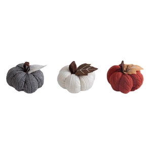 Three knitted pumpkins in gray, white, and orange colors for Thanksgiving decoration