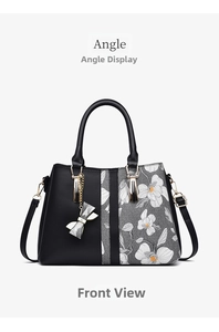 Front view of large capacity floral tote bag with bow charm and golden hardware