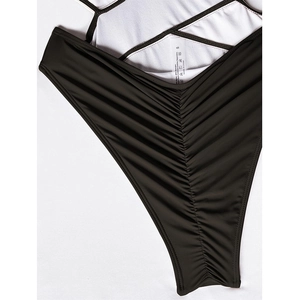 Detail view of swimsuit texture showing high-quality nylon fabric and product wash label