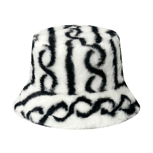 Detailed view of plush faux fur bucket hat with black and white wavy chain pattern