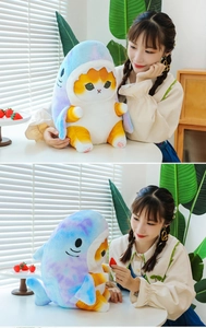 Detailed views of creative shark-costume cat plush toy held in a cozy home setting